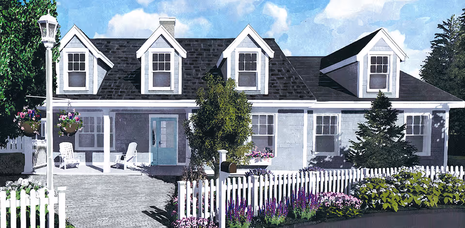 Front exterior of a cottage-style house with dormer windows, a white picket fence, porch seating, and landscaped flowers.