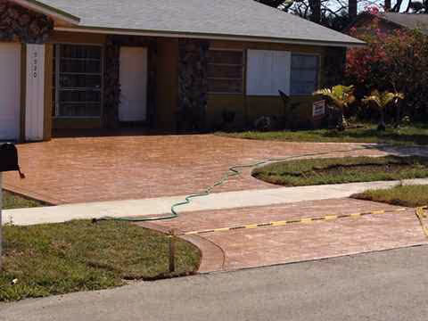 Front exterior of a single-story assisted living facility with a brick-paver driveway.