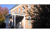 Brick Notre Dame Health and Rehabilitation Center exterior featuring a columned porch and autumn trees.