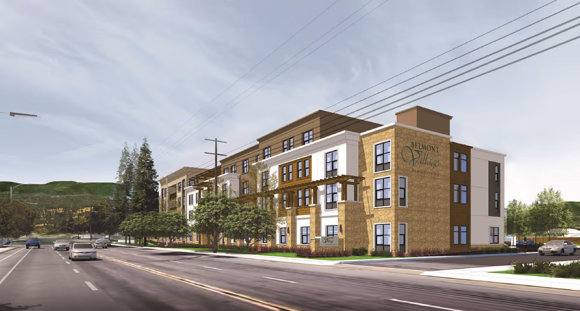 Exterior view of Belmont Village Senior Living Los Gatos, a multi-story building with a mix of stone and white facade, large windows, and trees along the sidewalk. Cars are driving on the road in front of the building under a partly cloudy sky.