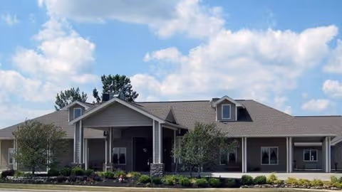 Front view of Maple Terrace senior living facility with entrance and landscaping.