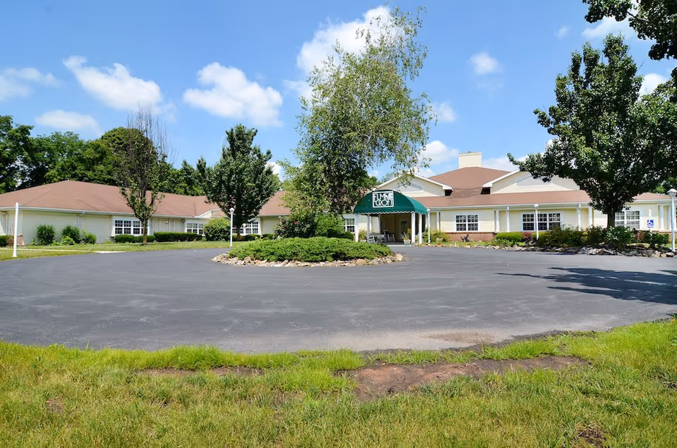 Exterior view of Celebration Villa of Dillsburg with circular driveway and entrance canopy.