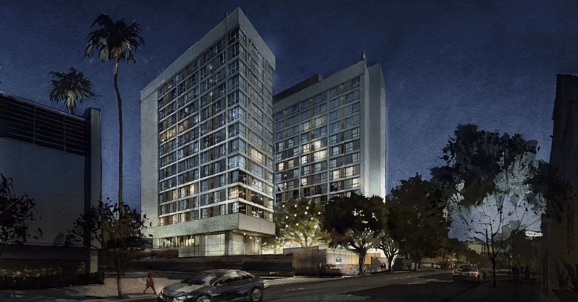 Nighttime view of a tall, modern residential building with many windows illuminated, surrounded by trees and streetlights, with cars parked along the street and a few people walking nearby.