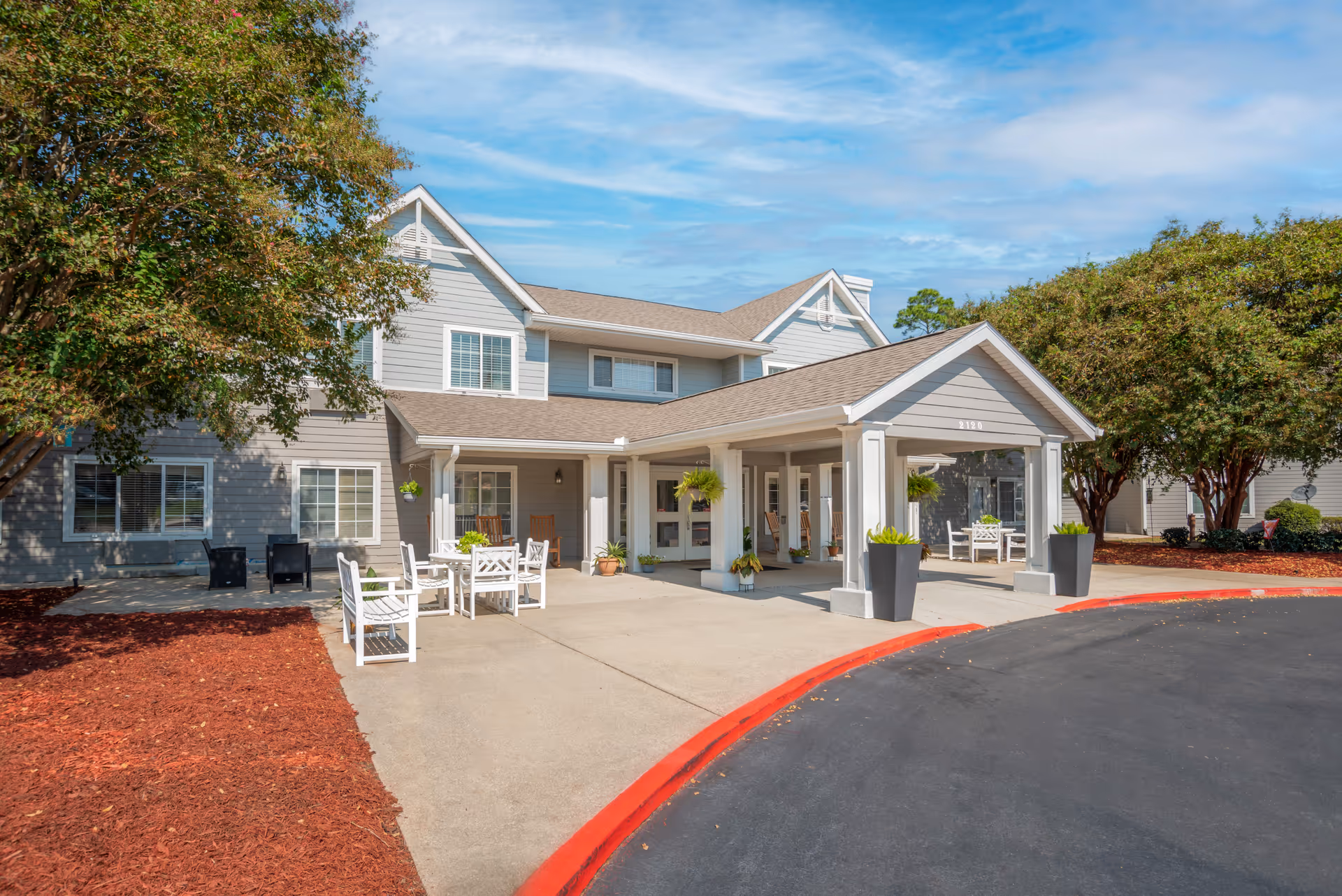 Front entrance of Brookdale Biloxi with a covered porch and outdoor seating.