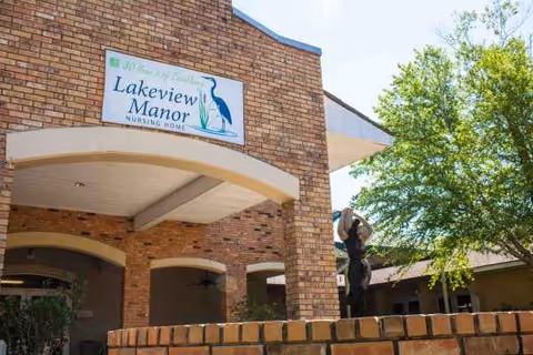 Exterior view of Lakeview Manor Nursing Home with brick façade and arched entrance.