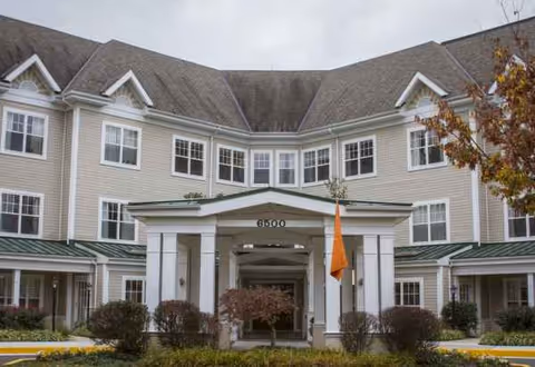 Exterior view of Sunrise of Columbia showing a two-story front entrance with a porte-cochere.