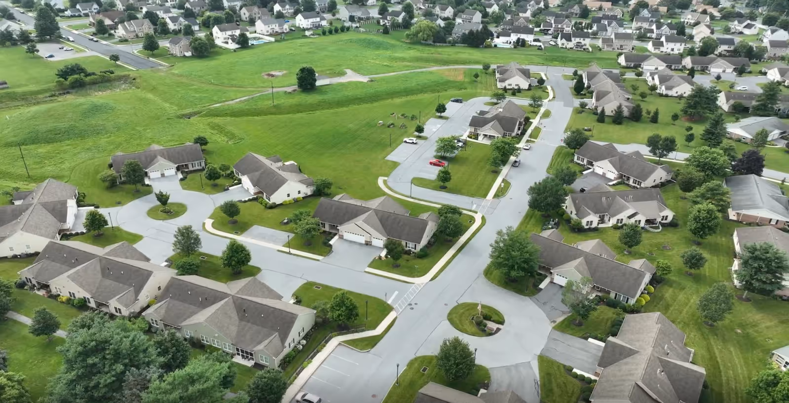 Aerial view of Mount Joy Country Homes campus with townhome buildings and green lawns.