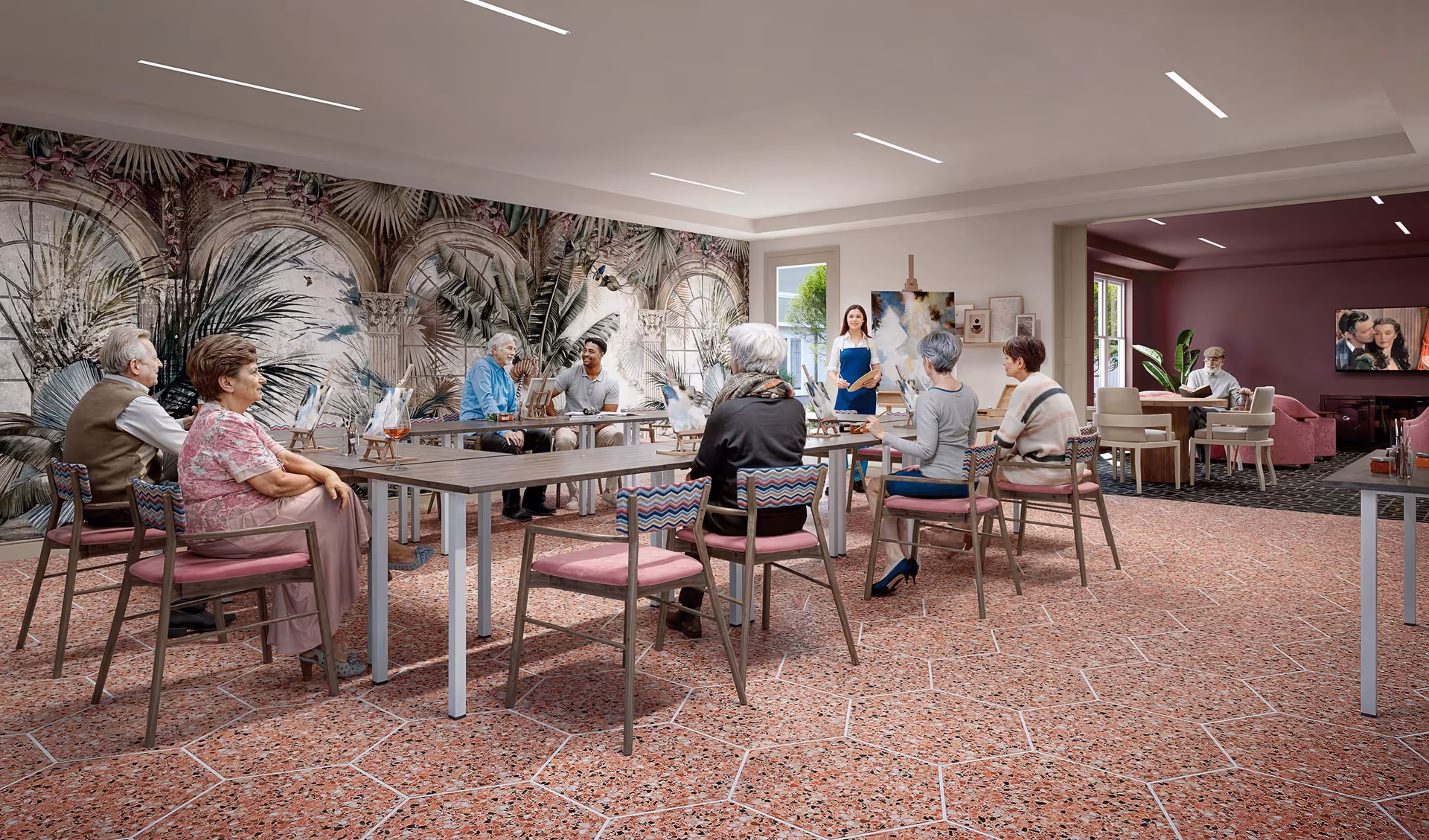 A group of seniors seated around tables in a bright activity room as an instructor leads an art session.