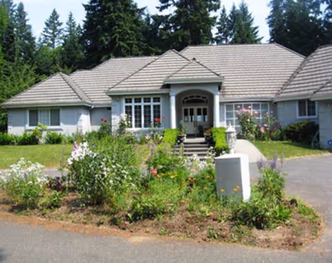 Front view of a single-story senior care facility with a landscaped garden.