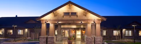 Front view of Spring Creek Inn Memory Care Community entrance at dusk.
