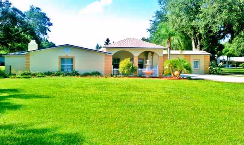 Single-story assisted living building with a green lawn and front entrance.