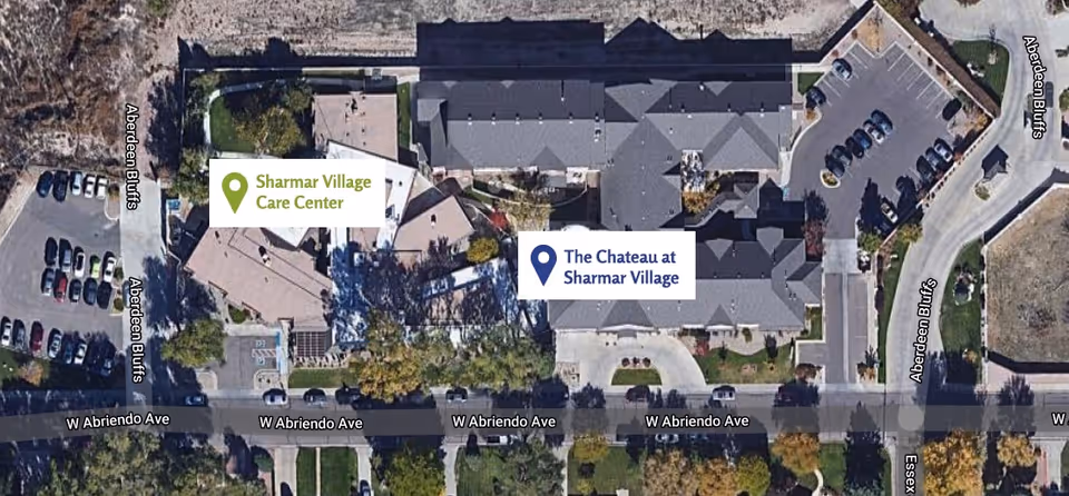 Aerial view of the Chateau at Sharmar Village assisted living facility and Sharmar Village Care Center, showing buildings, parking lots, surrounding roads, and landscaping.