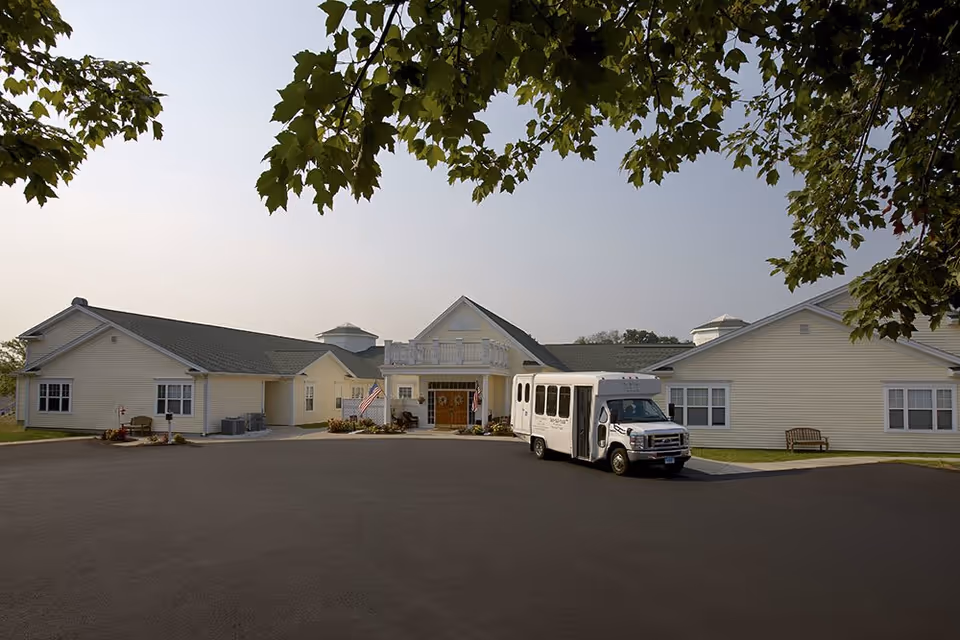 Exterior view of The Atrium at Rocky Hill with a bus in front of the entrance.