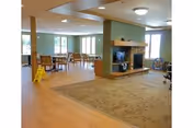 Communal living room in Park Place Assisted Living with fireplace and seating.