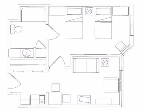 Architectural floor plan showing a living space with two beds, a bathroom with a toilet and sink, a living room area with sofa and chairs, and an entryway with additional seating and a small kitchenette area.
