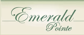 Emerald Pointe sign with cursive logo on a light wall with green accents.