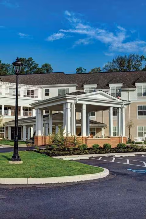 Exterior view of Sunrise of North Wales showing the entrance canopy and parking area.