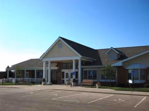 Front view of Hoeger House senior living facility with entrance and parking.