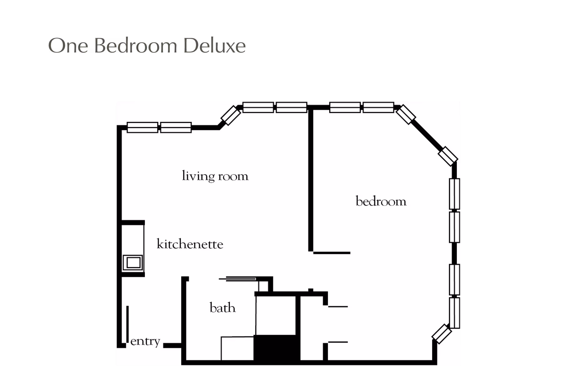 Floor plan layout of a one bedroom deluxe apartment showing labeled areas including living room, bedroom, kitchenette, bath, and entry.