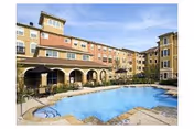 Outdoor pool area in front of Evergreen at Plano senior living building.