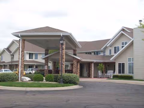 Exterior view of Linden Estates senior living facility with a covered entrance and parked cars.
