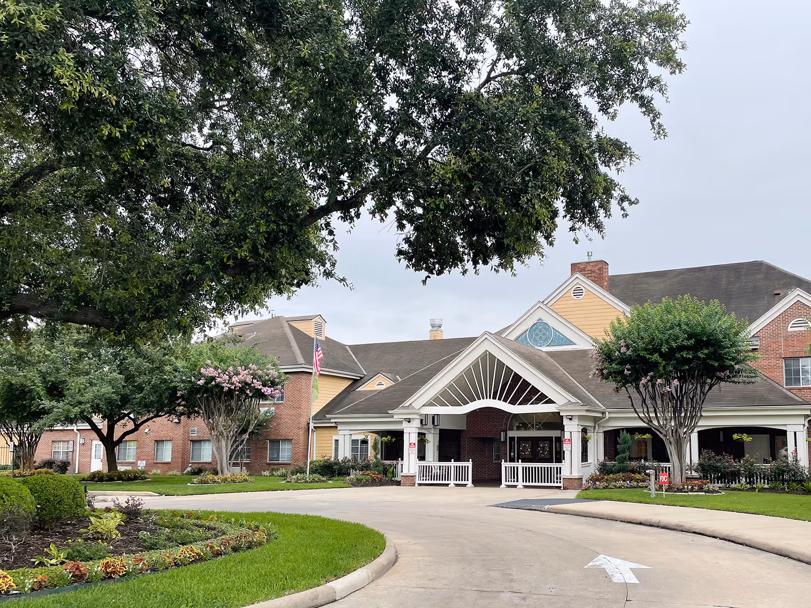 Atria Westchase front entrance, curved driveway, and landscaped grounds.