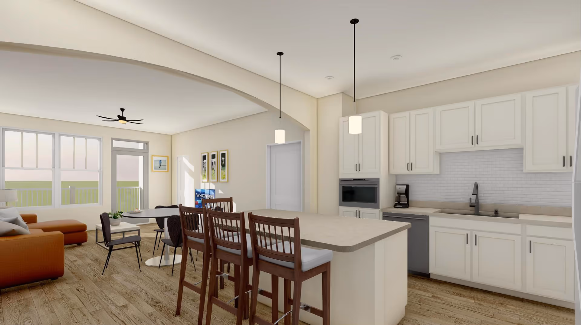 Open-concept kitchen and living area with a central island and bar stools, white cabinets, and a seating area by large windows.