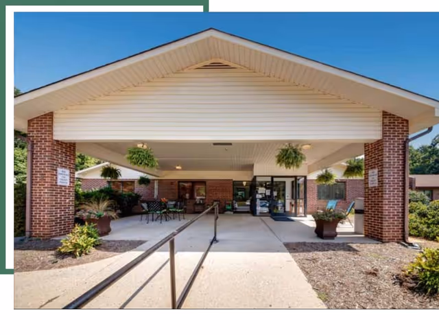 Covered entrance to Eden Rehabilitation and Healthcare Center with brick columns and outdoor seating
