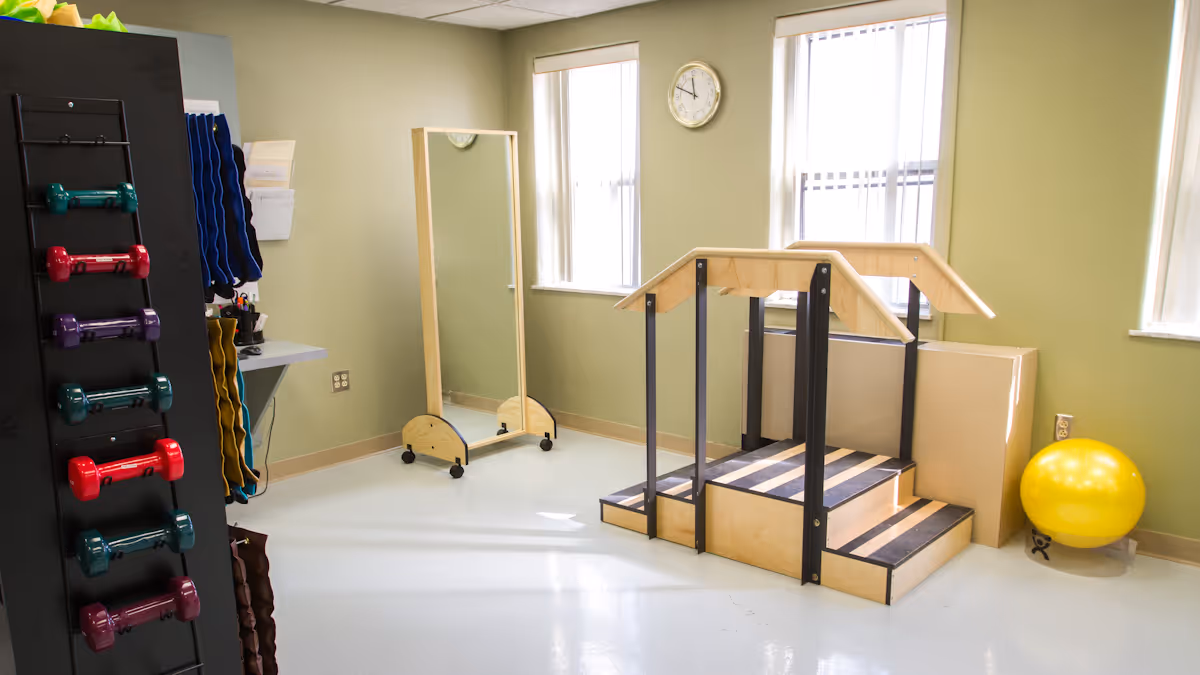A small rehabilitation room with practice stairs and handrails, a rack of colorful dumbbells, a full-length mirror, and a yellow exercise ball.