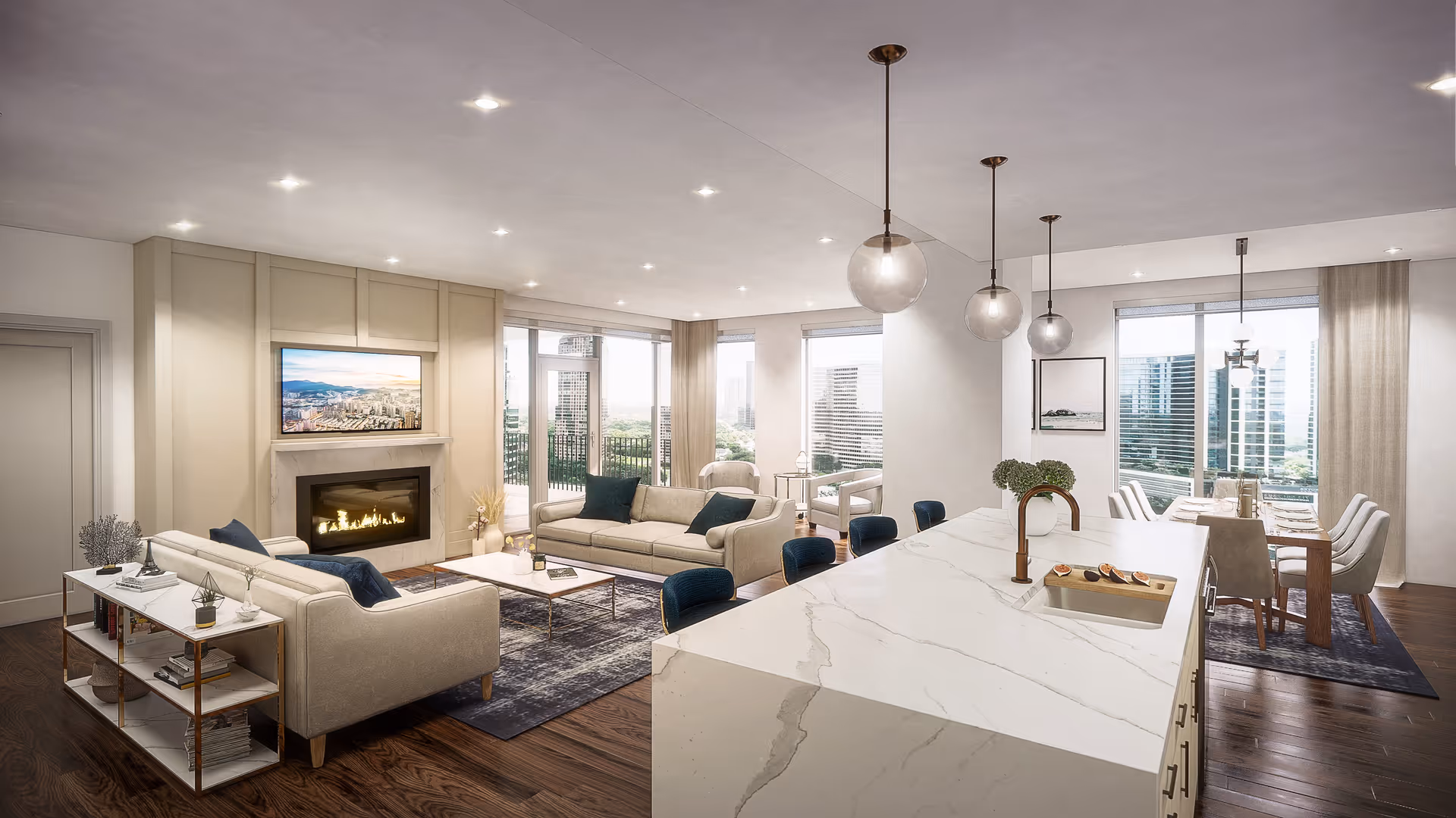 Spacious open-plan living area with sofas around a fireplace, a large marble kitchen island, and a dining table by floor-to-ceiling windows.