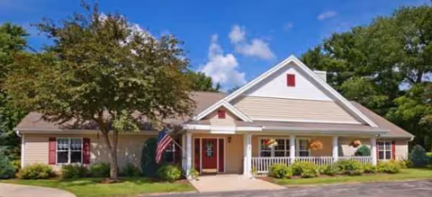 Single-story senior living facility with front porch and landscaping.