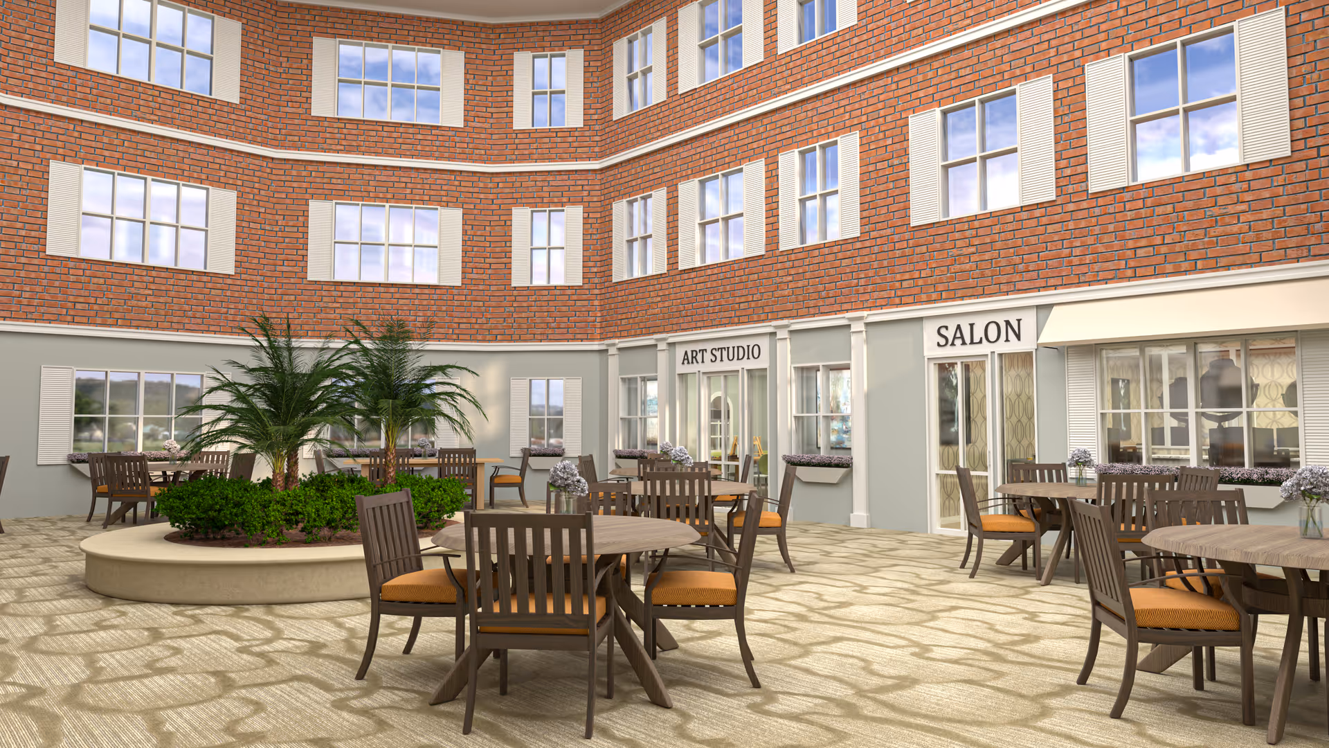 Outdoor courtyard area with round tables and chairs arranged on a patterned stone floor. There are green plants and palm trees in a circular planter in the center. Surrounding the courtyard are windows and doors labeled 'Art Studio' and 'Salon' on a brick and light-colored building exterior.