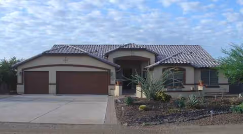 Desert Hills Adult Care Home exterior with desert landscaping and a three-car garage