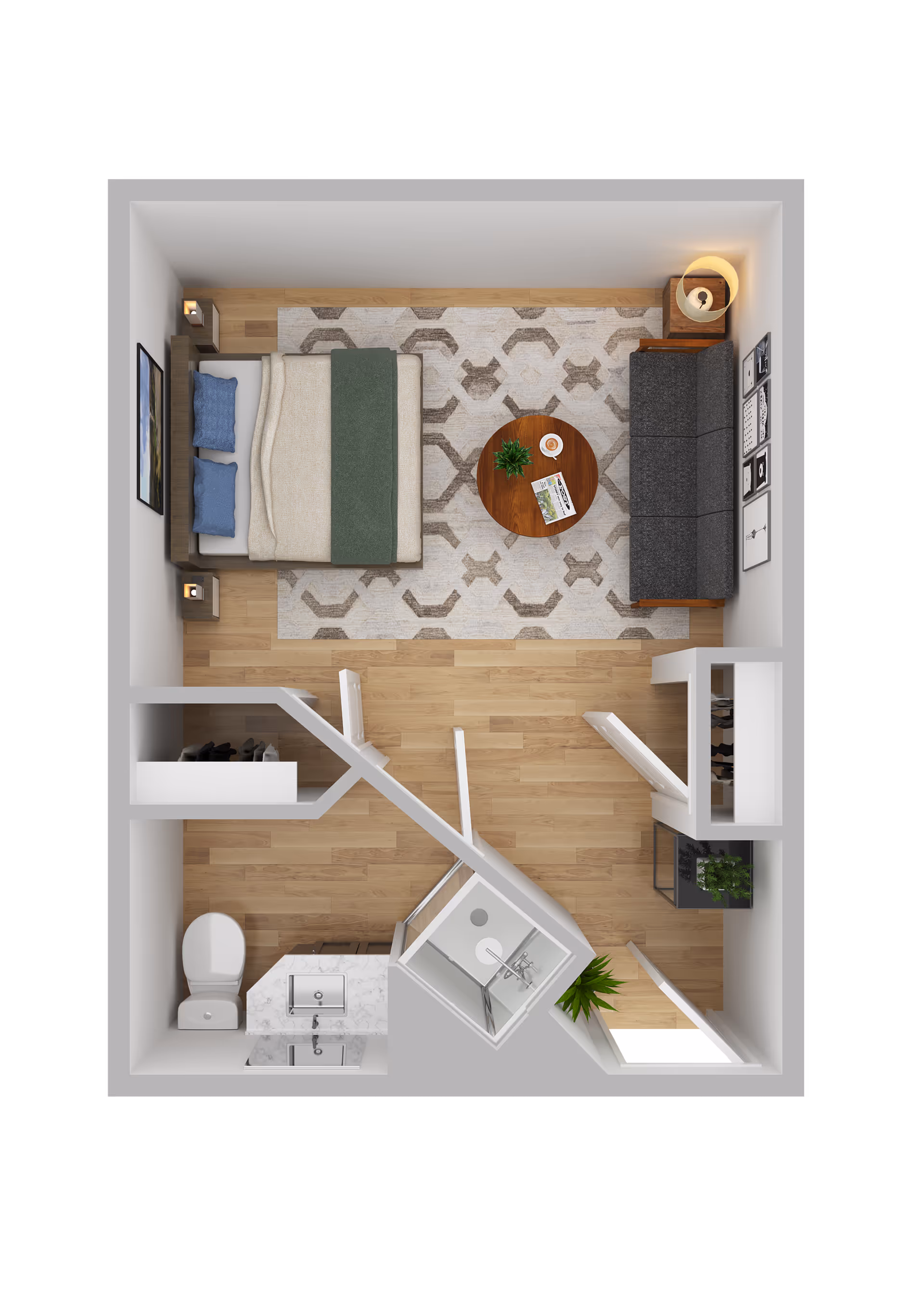 Top-down view of a small studio apartment layout featuring a bedroom area with a bed, two pillows, and a blanket, a living area with a dark gray sofa, round wooden coffee table with a plant and magazine, and a bathroom with a toilet, sink, and shower. The floor is wooden, and there is a patterned rug under the bed and coffee table. The room includes a closet and some wall decorations.