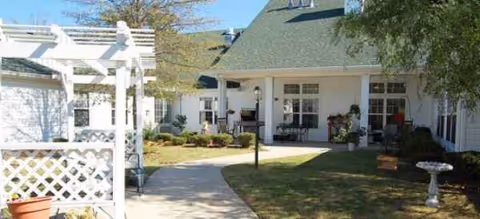 Exterior view of Brookdale Brushy Creek entrance with covered patio and landscaped lawn.