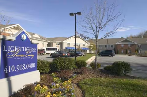 Exterior view of Lighthouse Senior Living at Hopkins Creek with parking and landscaping