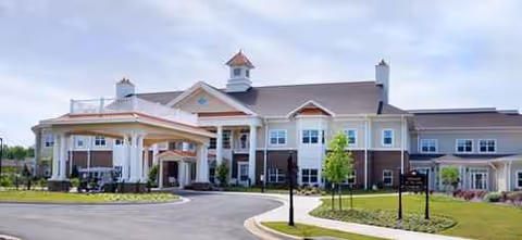 Exterior view of The Oaks of Louisiana, with circular driveway, porte-cochere, and landscaped grounds.