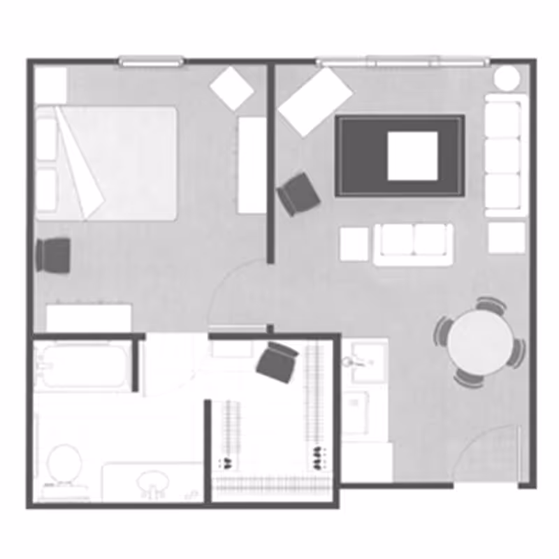Floor plan layout of a one-bedroom apartment showing a bedroom with a bed and chair, a living room with sofas, chairs, a coffee table, and a round dining table with four chairs, a kitchen area, a bathroom with a bathtub, toilet, and sink, and a closet space.