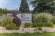 Landscaped front area with a sign reading "River's Edge" in front of a single-story rehabilitation and living center.