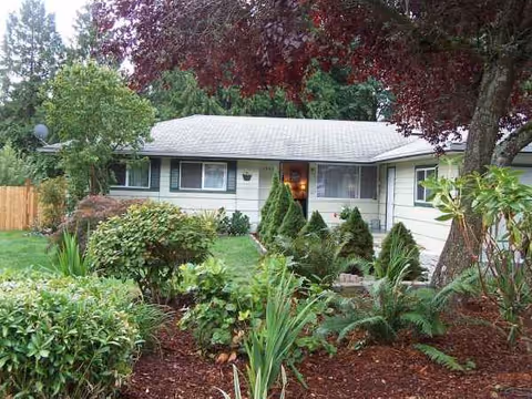 A single-story Evergreen AFH building with a landscaped front yard and visible entry door.