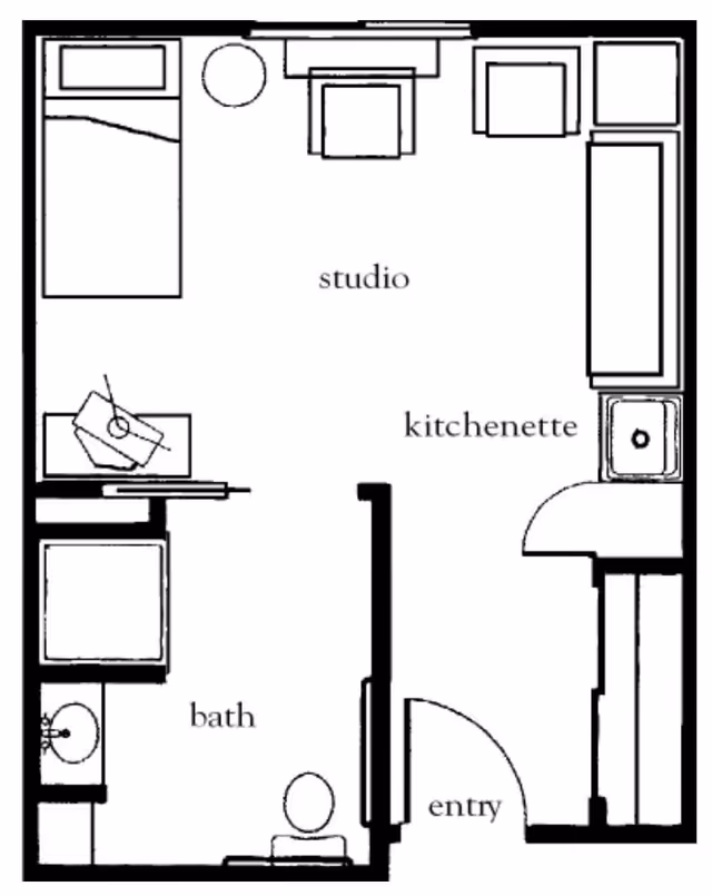 Floor plan of a studio apartment featuring a studio area with a bed, chair, and table, a kitchenette with a sink and counter space, a bathroom with a toilet, sink, and bathtub, and an entry door.