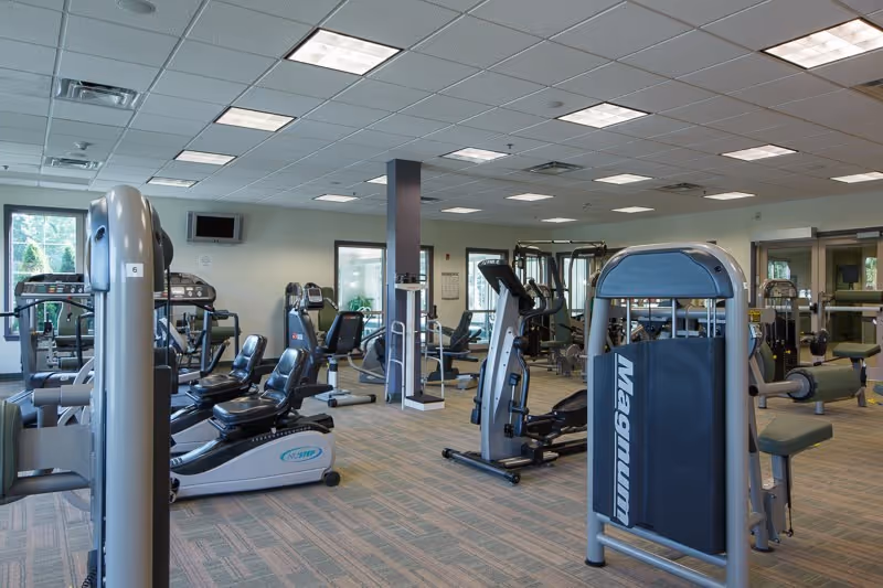 Spacious, well-lit fitness center with cardio and strength-training machines.