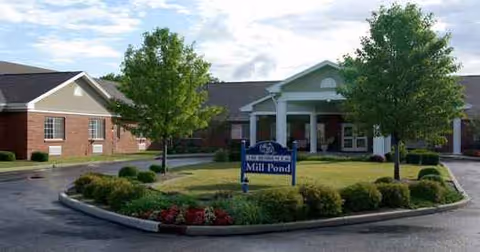 Exterior view of Mill Pond Health Campus with a circular driveway and landscaped entrance.