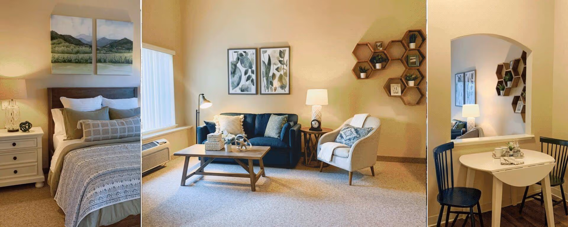 A collage of three images showing interior spaces of a senior living facility. The first image features a bedroom with a bed, pillows, a nightstand with a lamp, and landscape artwork above the headboard. The second image shows a living room area with a blue couch, a beige armchair, a wooden coffee table, side tables with lamps, and wall art including framed botanical prints and hexagonal shelves with small plants and decor. The third image depicts a small dining area with a white drop-leaf table, two black chairs, and a mirror reflecting part of the living room.