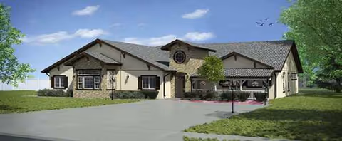 Single-story senior living facility exterior with manicured lawn and driveway.