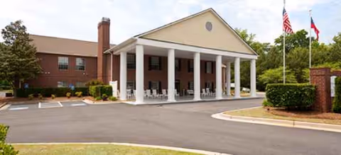Brookdale Lawrenceville building with a columned front entrance and flagpoles.