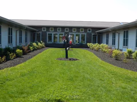 Well-kept courtyard with green lawn between two wings of VibraLife facility.