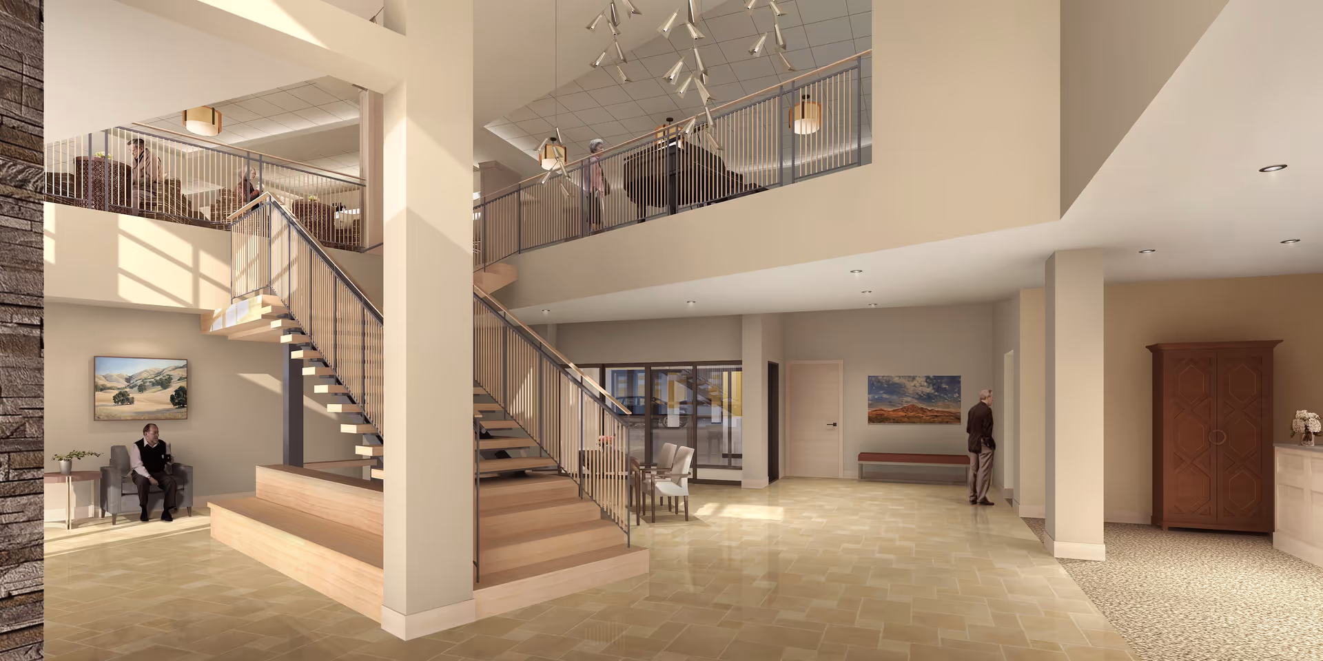 Spacious, well-lit interior of a senior living facility with a central wooden staircase leading to an upper level. Several elderly individuals are seated or standing around the area, which features beige walls, tiled floors, modern lighting fixtures, and framed landscape artwork on the walls. There is a wooden cabinet and a reception desk on the right side.