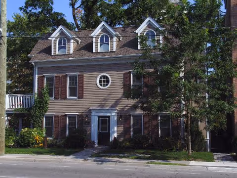Walnut House exterior: a two-story brown building with dormer windows.