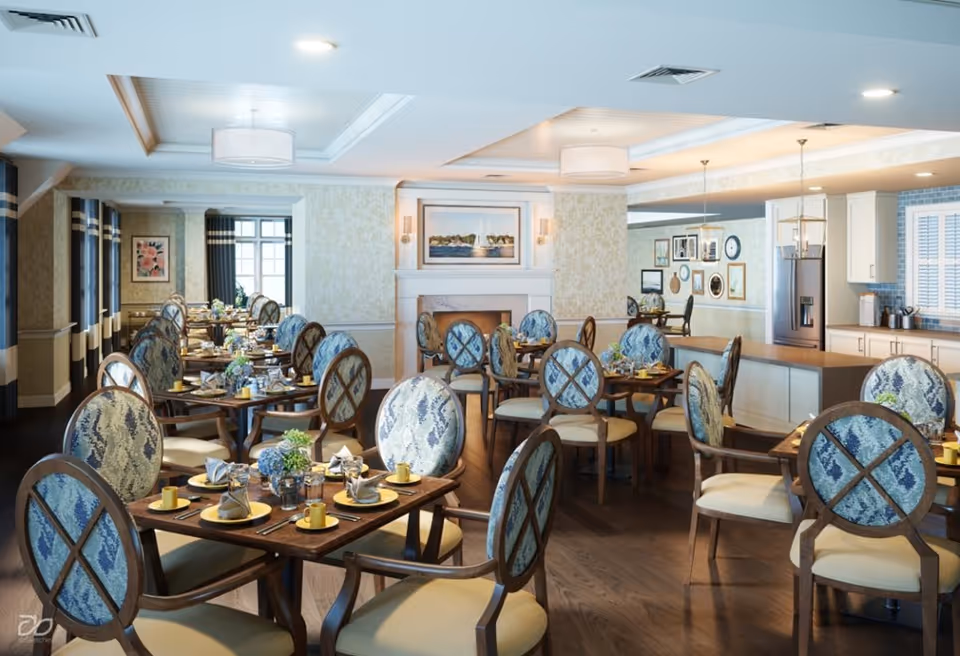 Bright, spacious dining room with multiple set tables and patterned upholstered chairs and a serving counter in the background.